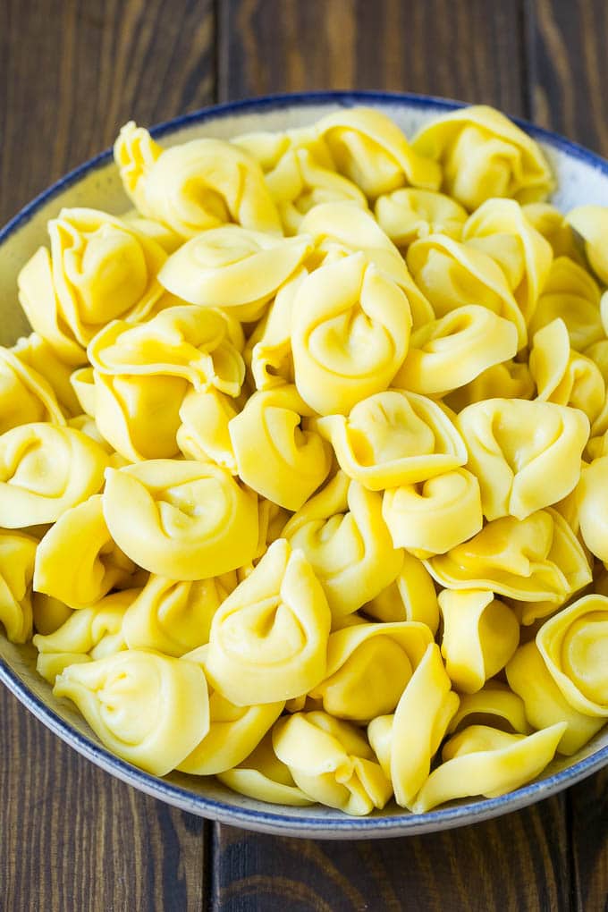 Greek Tortellini Salad Recipe | Pasta Salad | Tortellini Salad | Greek Salad #greek #tortellini #pasta #salad #cucumbers #olives #dinner #ezlod A bowl of cooked cheese tortellini.