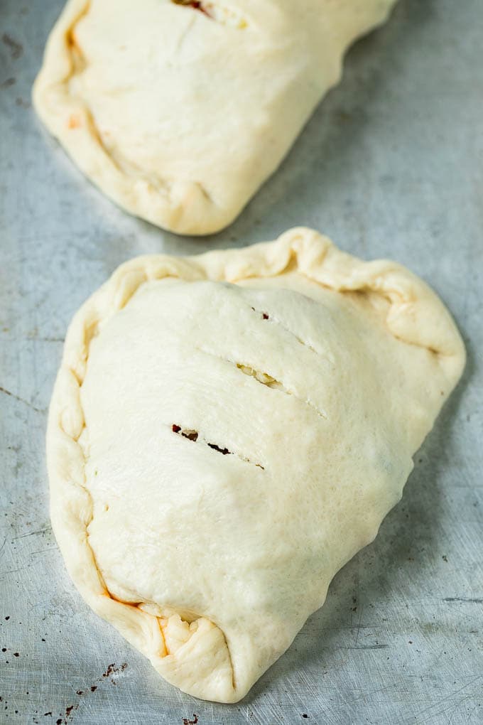 Calzone Recipe | Pizza Pockets #pizza #calzone #pepperoni #sausage #peppers #dinner #ezlod #cheese Unbaked calzones ready to go into the oven.