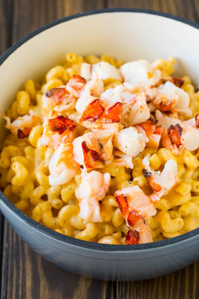 Lobster Mac and Cheese Recipe | Lobster Macaroni and Cheese | Baked Mac and Cheese #pasta #macandcheese #macaroni #lobster #cheese #dinner #ezlod Stove top mac and cheese topped with pieces of cooked lobster.