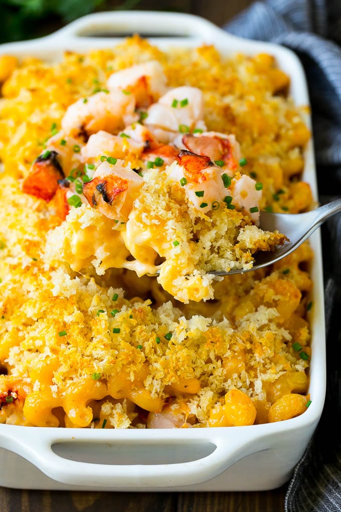 Lobster Mac and Cheese Recipe | Lobster Macaroni and Cheese | Baked Mac and Cheese #pasta #macandcheese #macaroni #lobster #cheese #dinner #ezlod A spoon serving up a portion of lobster mac and cheese.