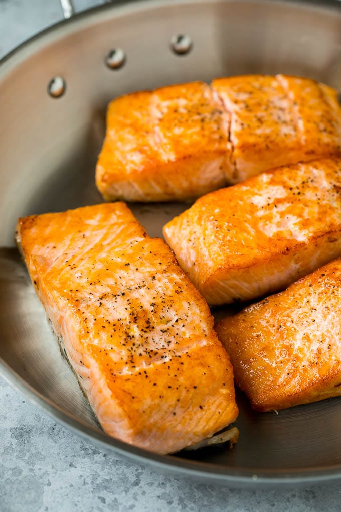 Pan Seared Salmon Recipe | Garlic Butter Salmon | Seared Salmon #salmon #garlic #butter #keto #lowcarb #dinner #ezlod Sauteed salmon fillets in a metal skillet.