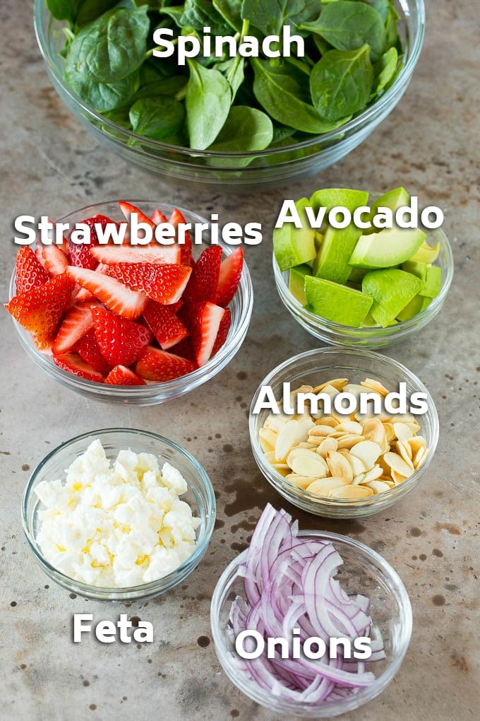 Strawberry Spinach Salad Recipe | Strawberry Salad | Spinach Salad #spinach #salad #strawberries #avocado #ezlod Bowls of ingredients like feta cheese, almonds, red onion and avocado.