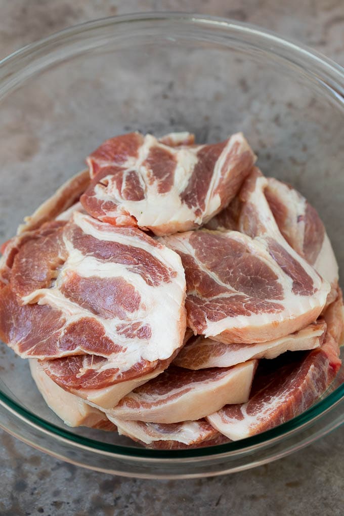 Tacos al Pastor Recipe | Pork Tacos | Mexican Tacos #tacos #pork #pineapple #grilling #tacotuesday #dinner #ezlod Sliced pork shoulder in a bowl.