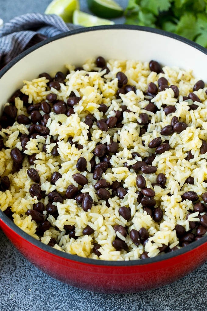 Black Beans and Rice Recipe | Cuban Black Beans | Beans and Rice #beans #rice #blackbeans #sidedish #glutenfree #dinner #ezlod Rice and beans mixed together in a red pot.