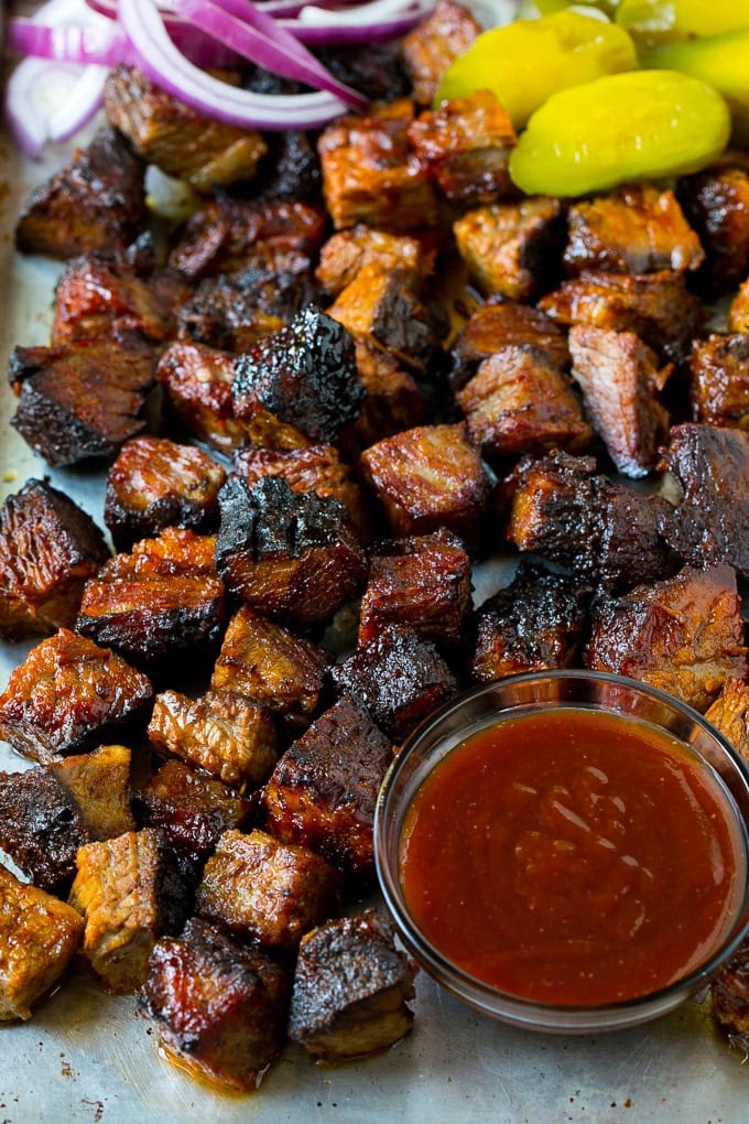 Burnt Ends Recipe | Smoked Brisket | Beef Brisket #brisket #bbq #smoker #beef #dinner #ezlod Burnt ends on a sheet pan served with BBQ sauce, red onions and pickles.