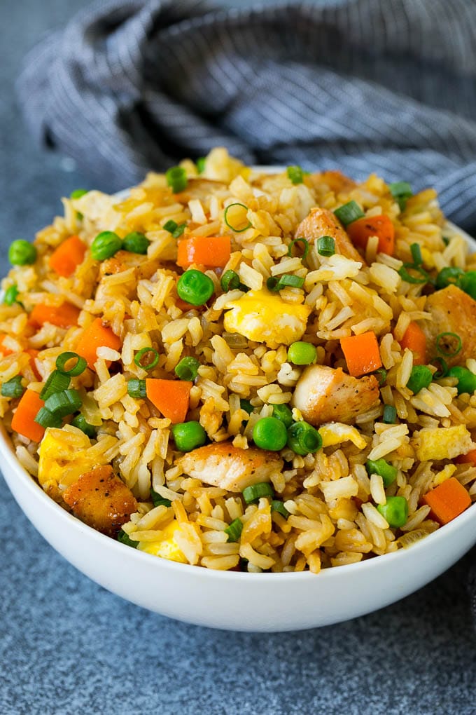 Chicken Fried Rice Recipe | Chinese Fried Rice #rice #chicken #peas #carrots #sidedish #dinner #ezlod A bowl of chicken fried rice topped with sliced green onions.