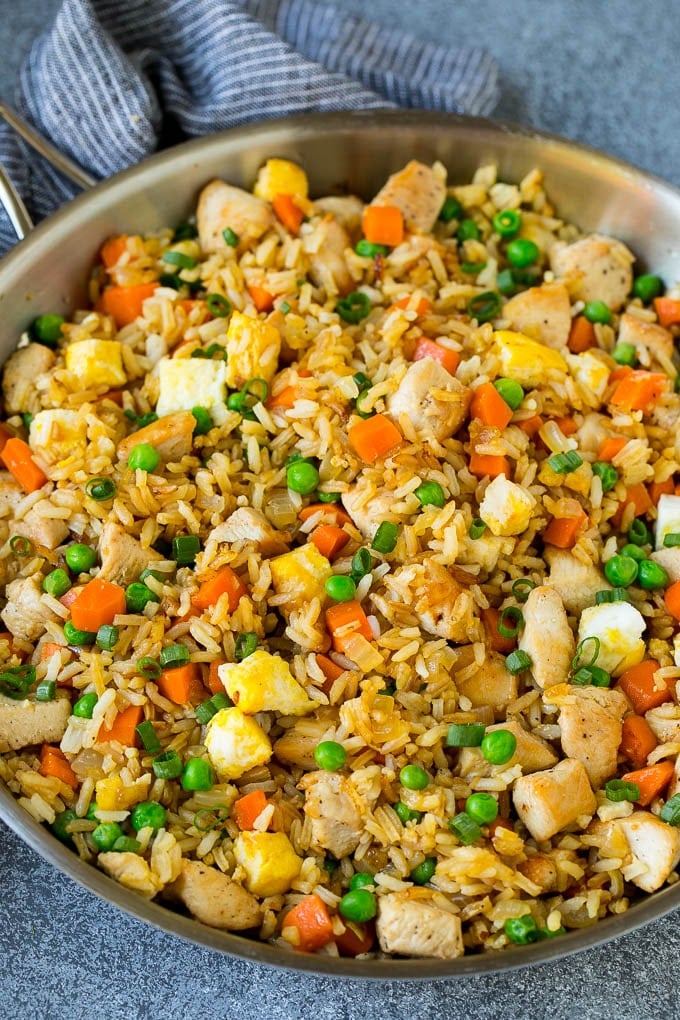 Chicken Fried Rice Recipe | Chinese Fried Rice #rice #chicken #peas #carrots #sidedish #dinner #ezlod A pan of chicken fried rice with eggs and vegetables.