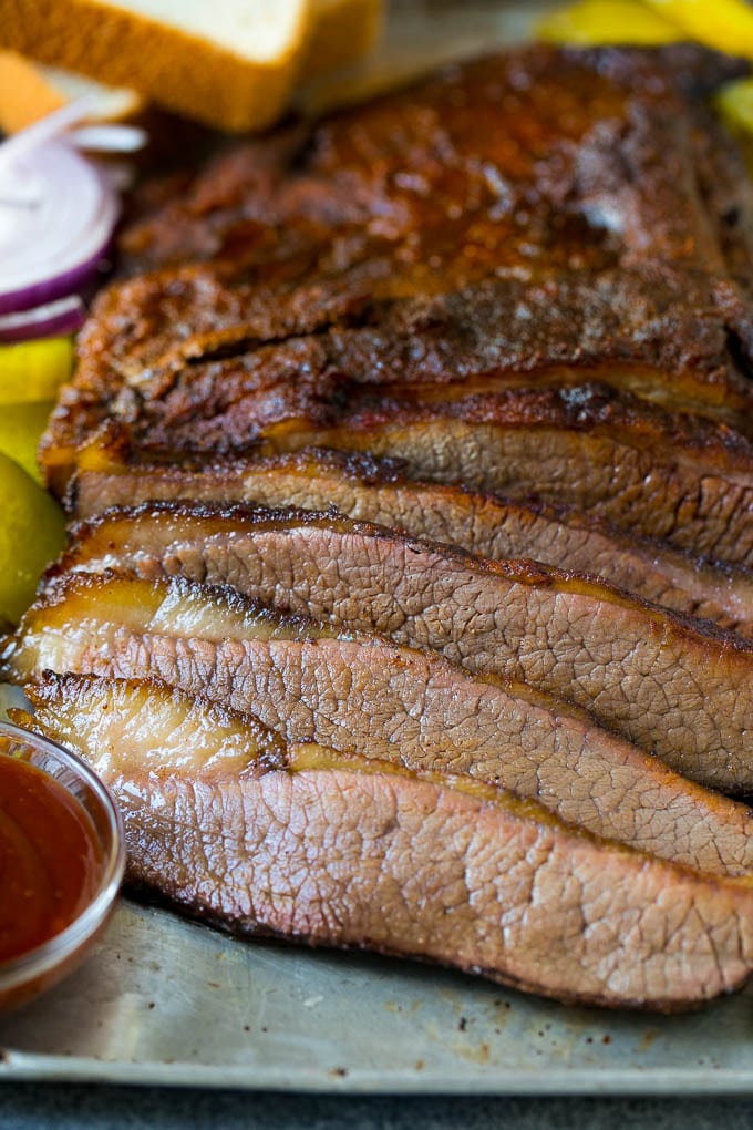 Smoked Brisket Recipe | Beef Brisket | BBQ Beef #brisket #smoker #beef #bbq #dinner #ezlod Sliced smoked brisket with a side of BBQ sauce.