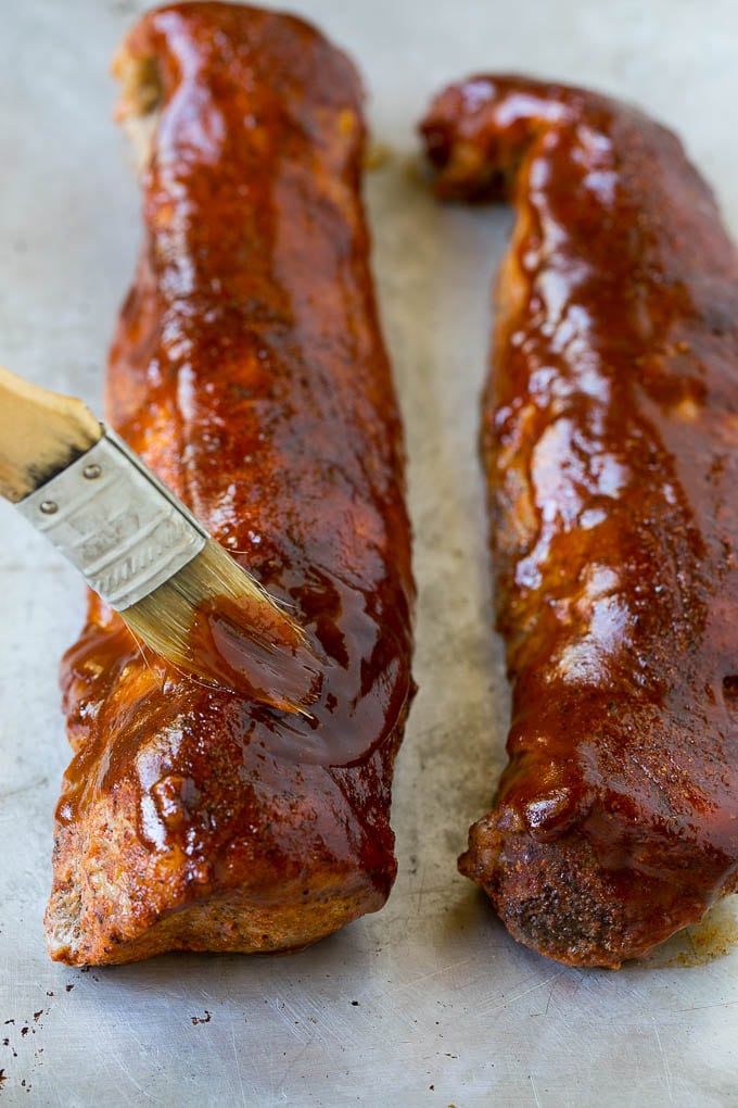 Smoked Pork Tenderloin Recipe | Smoked Pork Loin | BBQ Pork #pork #tenderloin #smoker #dinner #ezlod BBQ sauce being brushed over smoked pork loin.