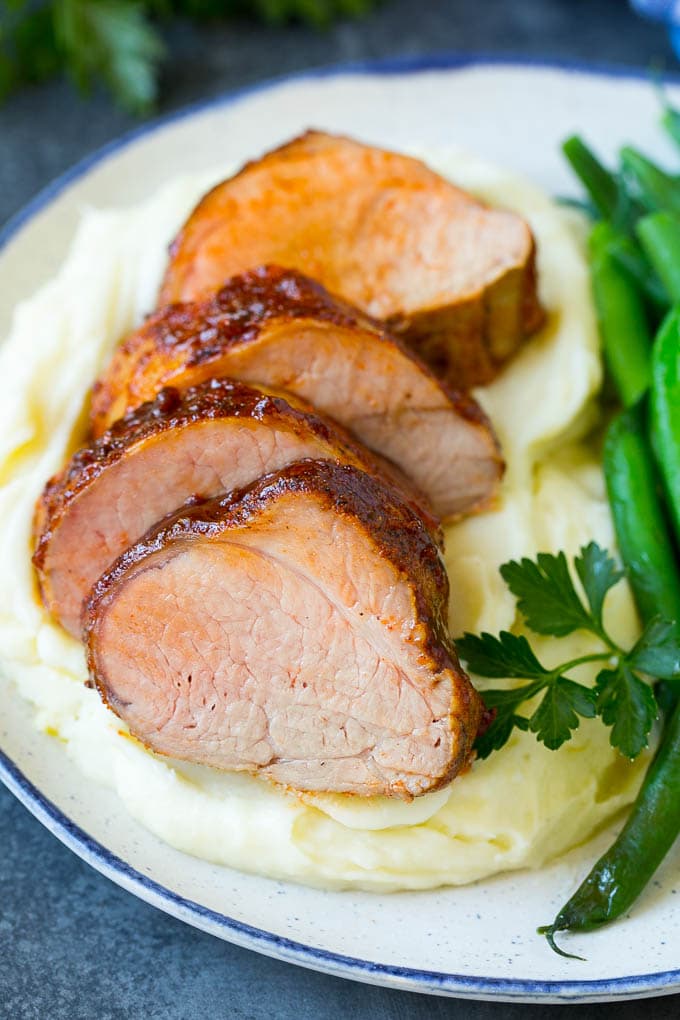 Smoked Pork Tenderloin Recipe | Smoked Pork Loin | BBQ Pork #pork #tenderloin #smoker #dinner #ezlod Sliced smoked pork tenderloin served with mashed potatoes and vegetables.