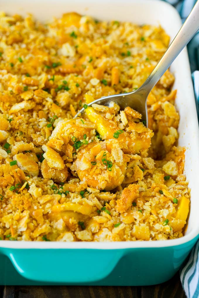 Squash Casserole Recipe | Vegetable Casserole | Zucchini Casserole #casserole #squash #zucchini #cheese #sidedish #ezlod A serving spoon in a dish of squash casserole.
