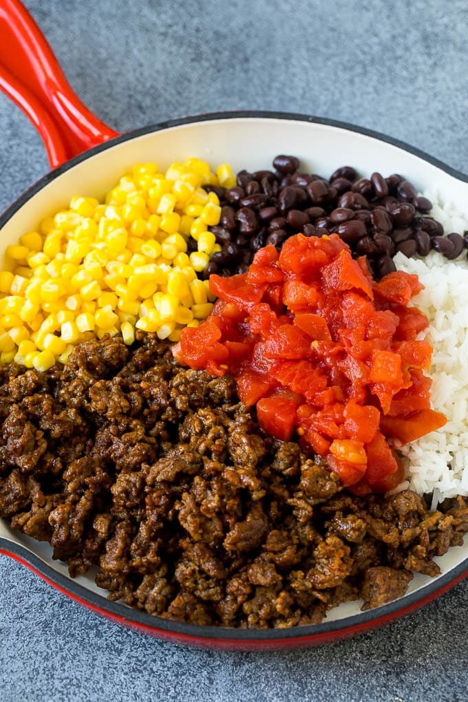 Stuffed Poblano Peppers | Stuffed Peppers | Pasilla Peppers #peppers #stuffedpeppers #beef #rice #beans #corn #dinner #ezlod A skillet filled with ground beef, rice, tomatoes, beans and corn.