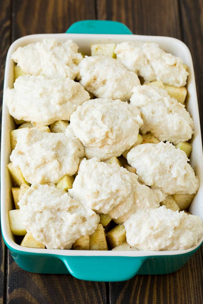 Apple Cobbler Recipe | Apple Dessert #apples #cobbler #dessert #baking #fall #ezlod Fruit in a baking dish with dough over the top.