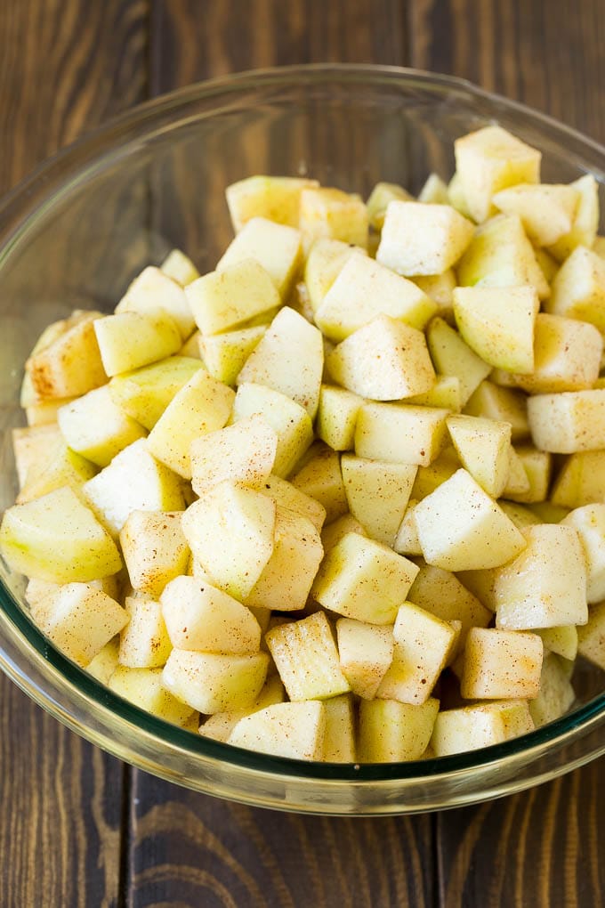 Apple Crisp Recipe | Apple Dessert #apples #dessert #baking #fall #ezlod Diced apples tossed with sugar and cinnamon in a bowl.
