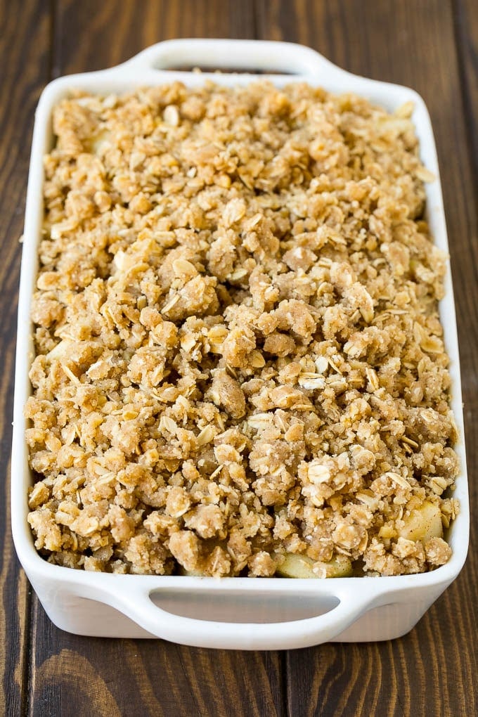 Apple Crisp Recipe | Apple Dessert #apples #dessert #baking #fall #ezlod Apples in a baking dish topped with brown sugar crumble.