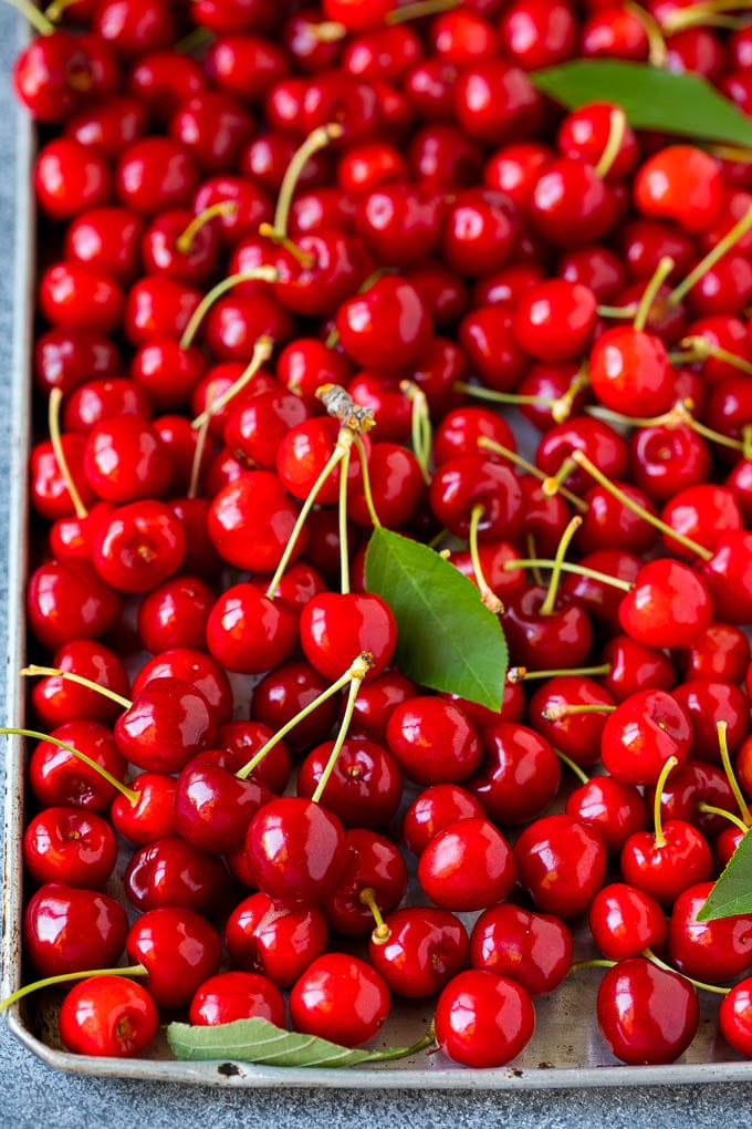 Cherry Pie Filling Recipe #pie #cherries #dessert #sweets #ezlod #summer Fresh cherries spread out on a sheet pan.
