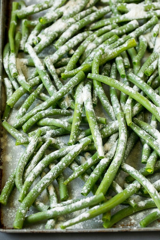 Fried Green Beans Recipe | Green Beans #greenbeans #appetizer #snack #ezlod Bean coated in flour on a pan.