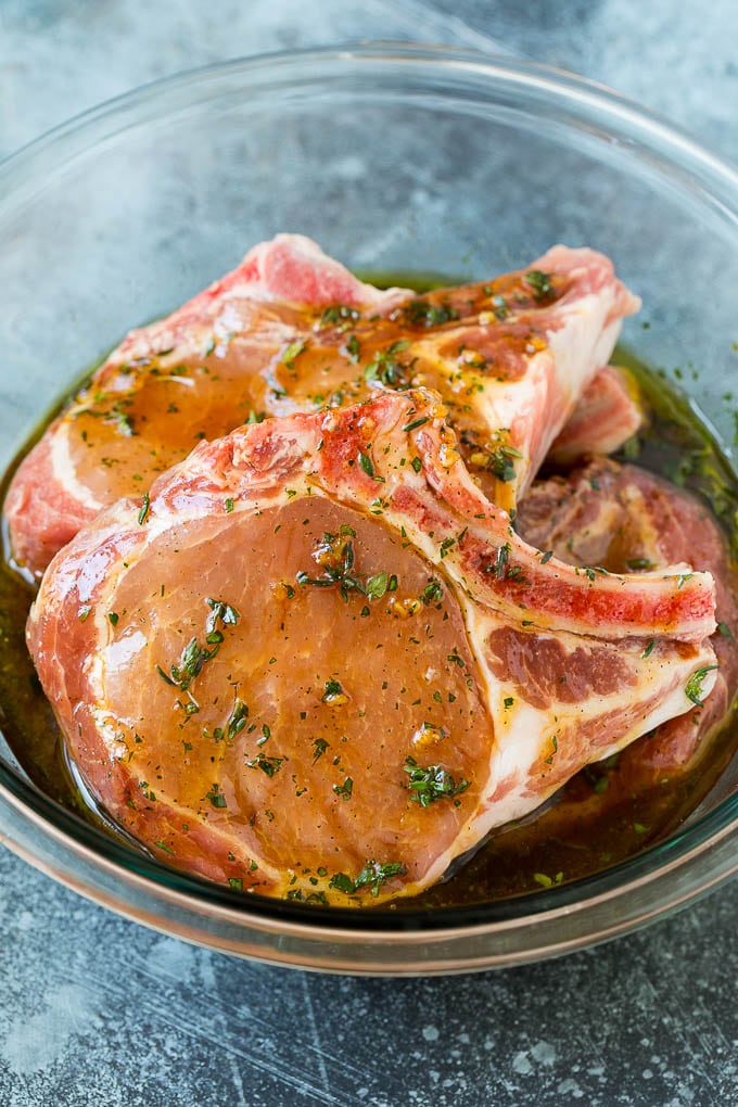 Grilled Pork Chops | Pork Chop Marinade #porkchops #grilling #pork #marinade #dinner #ezlod Pork chops in a bowl of marinade.