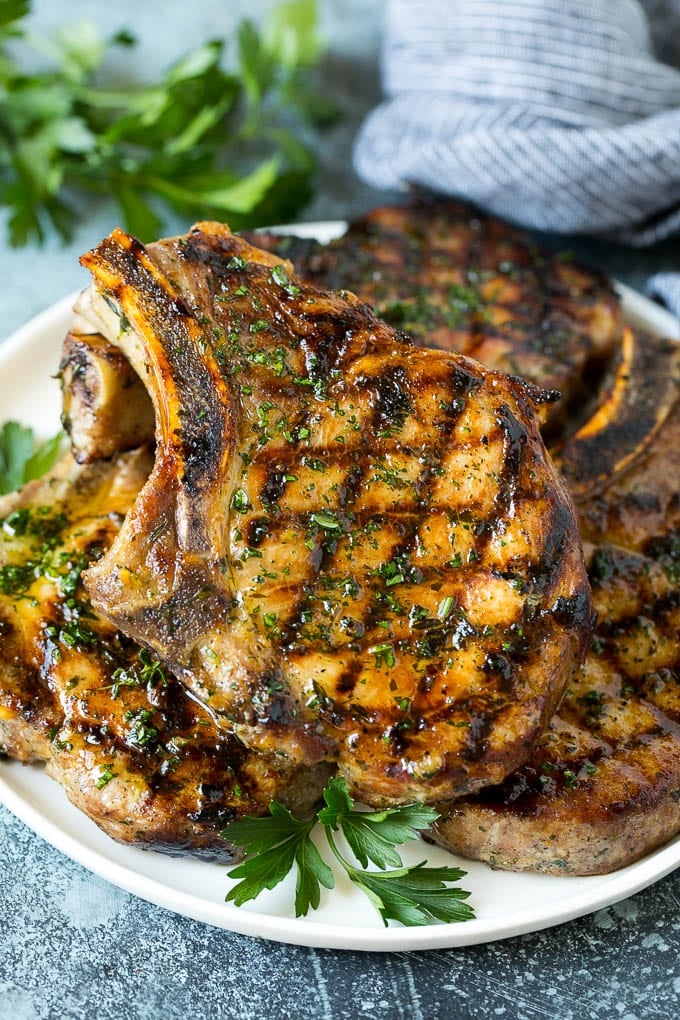 Grilled Pork Chops | Pork Chop Marinade #porkchops #grilling #pork #marinade #dinner #ezlod Grilled pork chops coated in marinade then cooked and garnished with parsley.