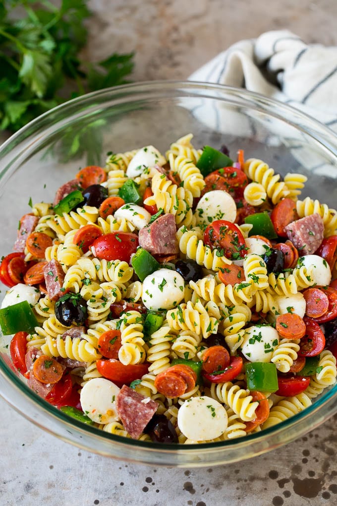 Italian Pasta Salad | Pasta Salad Recipe #pasta #salad #pastasalad #pepperoni #salami #olives #cheese #sidedish #ezlod A bowl of Italian pasta salad filled with meats, cheese and vegetables.