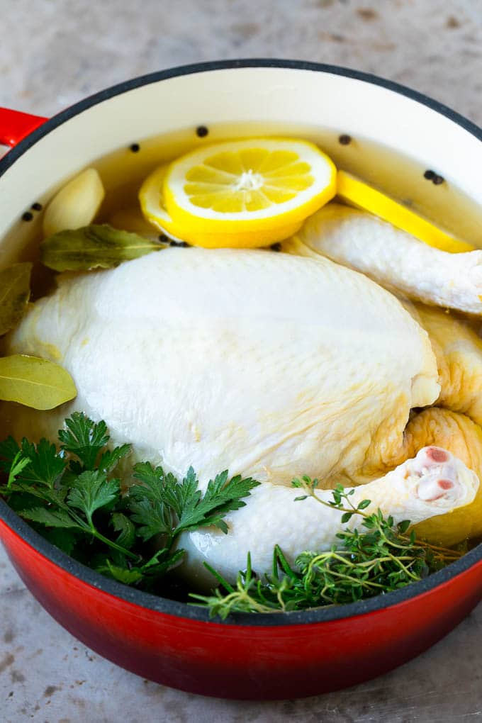 Rotisserie Chicken Recipe | Roasted Chicken #chicken #dinner #ezlod #comfortfood A whole chicken in a pot of brine.