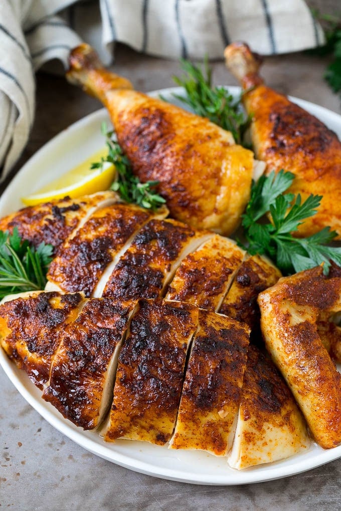 Rotisserie Chicken Recipe | Roasted Chicken #chicken #dinner #ezlod #comfortfood Sliced roasted chicken on a serving plate.