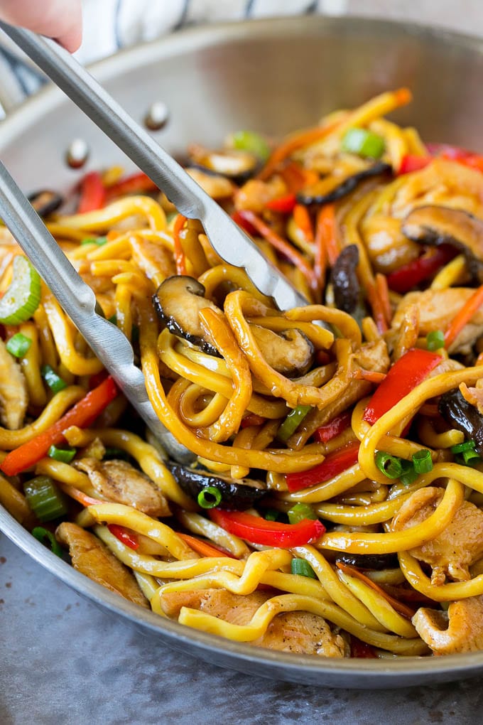 Stir Fry Noodles Recipe | Noodle Stir Fry #chicken #noodles #stirfry #mushrooms #dinner #ezlod Tongs serving up a portion of chicken and noodle stir fry.