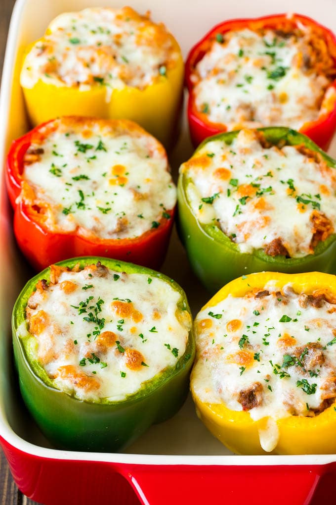 Stuffed Bell Peppers Recipe | Stuffed Peppers #beef #rice #peppers #dinner #cheese #ezlod Stuffed bell peppers in a baking dish topped with melted cheese.