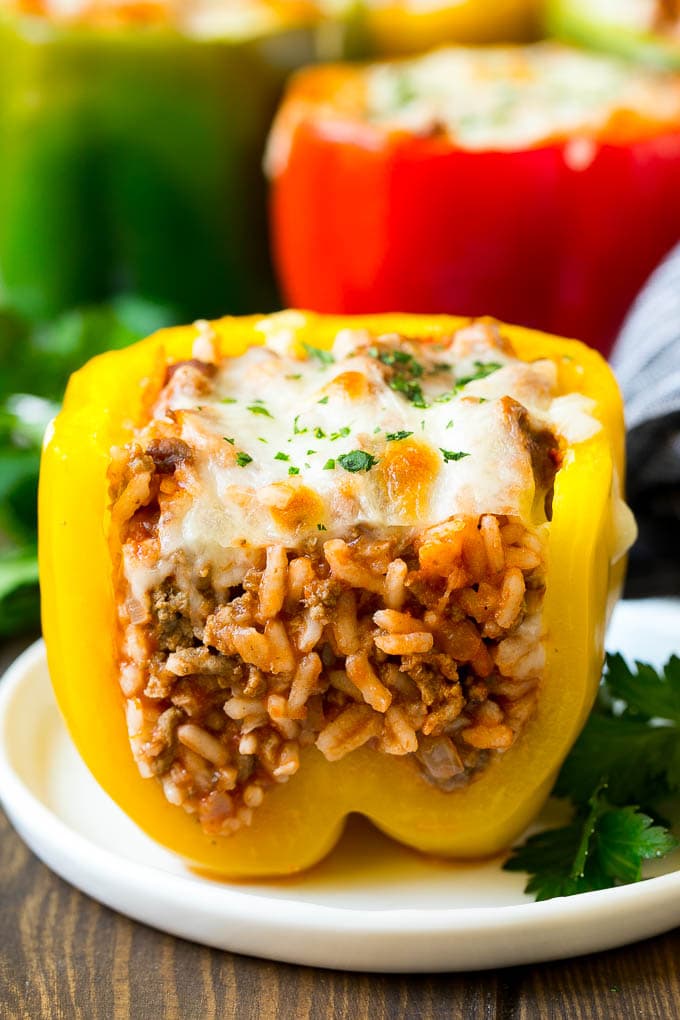 Stuffed Bell Peppers Recipe | Stuffed Peppers #beef #rice #peppers #dinner #cheese #ezlod A stuffed bell pepper cut open on a plate.