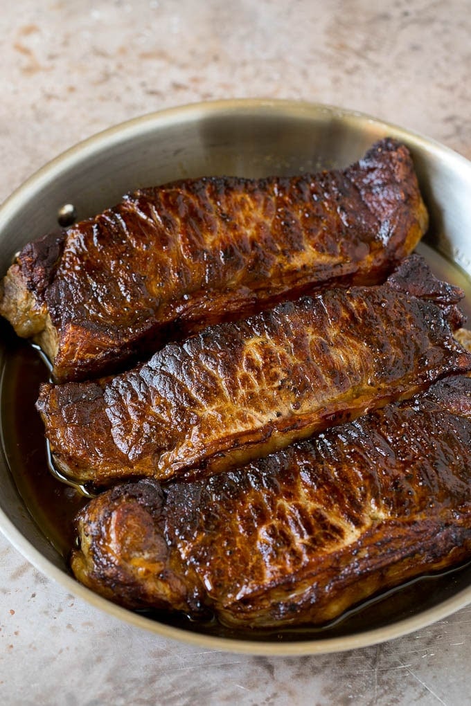Surf and Turf Recipe | Seared Steak #steak #shrimp #keto #lowcarb #dinner #ezlod Seared strip steaks in a skillet.