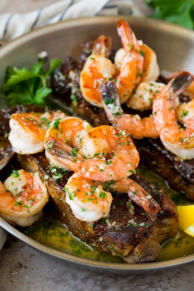 Surf and Turf Recipe | Seared Steak #steak #shrimp #keto #lowcarb #dinner #ezlod Surf and turf with seared strip steaks topped with jumbo shrimp in garlic butter.