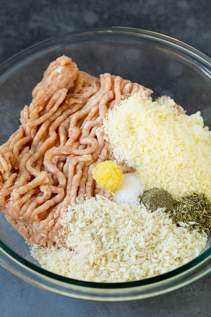 Chicken Meatballs Recipe | Baked Meatballs #chicken #meatballs #dinner #ezlod #comfortfood Ground chicken, herbs, breadcrumbs and cheese in a mixing bowl.