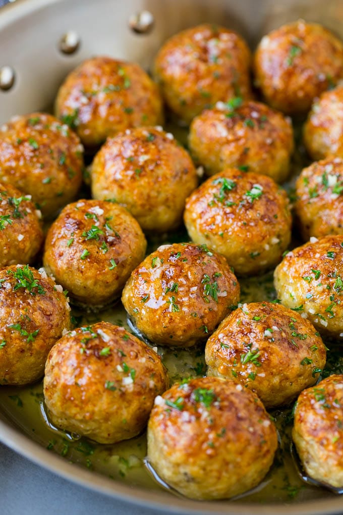 Chicken Meatballs Recipe | Baked Meatballs #chicken #meatballs #dinner #ezlod #comfortfood Chicken meatballs in a skillet of garlic butter.