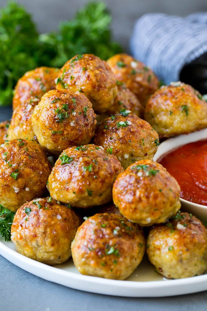 Chicken Meatballs Recipe | Baked Meatballs #chicken #meatballs #dinner #ezlod #comfortfood A serving plate of chicken meatballs served with marinara sauce.