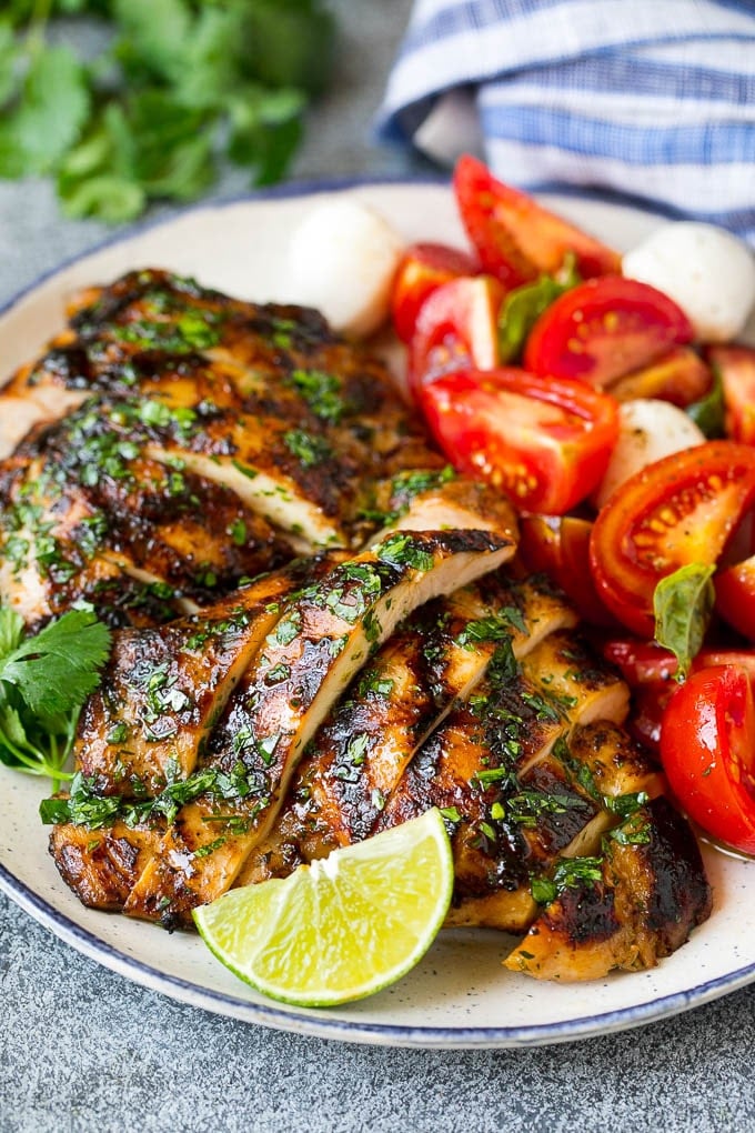Grilled Chicken Thighs Recipe | Marinated Chicken Thighs #chicken #grilling #marinade #dinner #cilantro #lime #ezlod Sliced chicken thighs served with tomato salad.