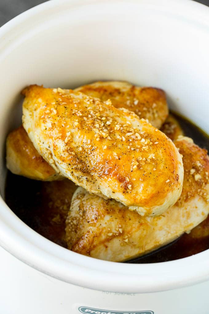 Slow Cooker Chicken Breast Recipe | Crock Pot Chicken Breast | Chicken and Gravy #chicken #slowcooker #crockpot #gravy #dinner #ezlod Chicken breasts with garlic and herb sauce poured over the top.