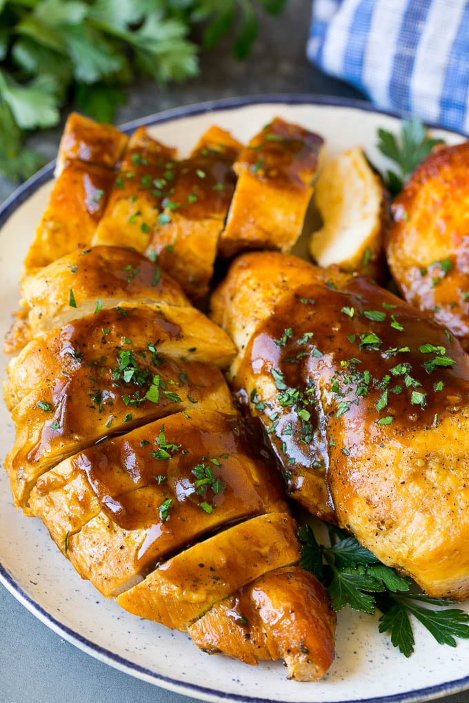 Slow Cooker Chicken Breast Recipe | Crock Pot Chicken Breast | Chicken and Gravy #chicken #slowcooker #crockpot #gravy #dinner #ezlod Sliced crock pot chicken breasts on a serving plate.