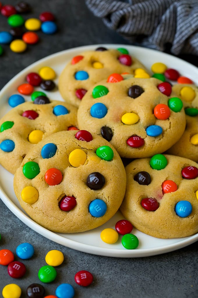M&M Cookies Recipe #cookies #chocolate #baking #dessert #sweets #ezlod A plate of M&M cookies, garnished with extra candy.
