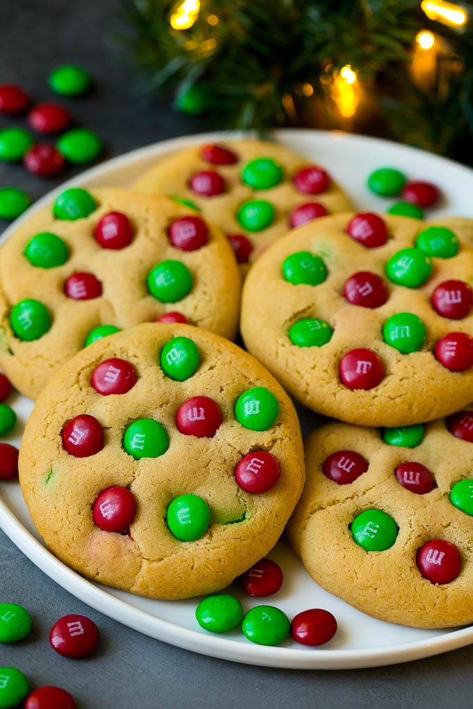 M&M Cookies Recipe #cookies #chocolate #baking #dessert #sweets #ezlod A plate of Christmas cookies with red and green M&Ms in them.