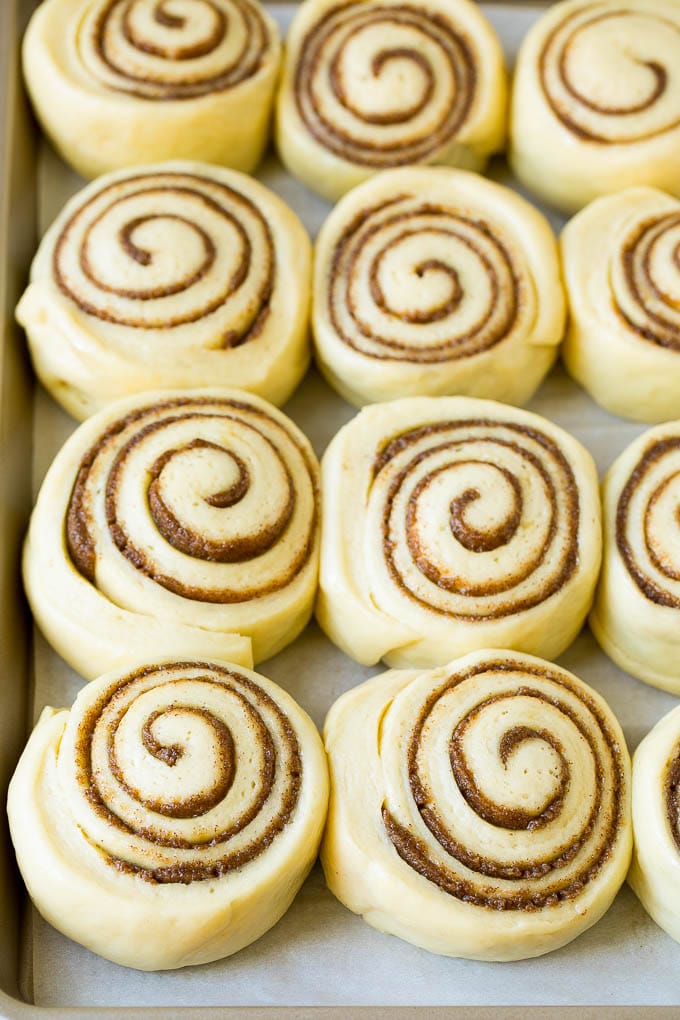 Cinnamon Rolls Recipe | Cinnamon Buns #cinnamon #rolls #pastry #breakfast #brunch #sweets #ezlod #baking #bread Rolls of dough and filling rising on a sheet pan.