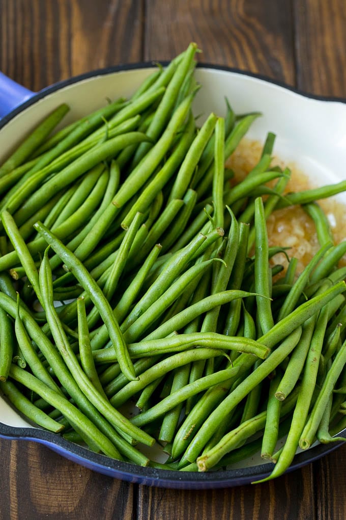 Green Beans with Bacon Recipe | Bacon Green Beans #bacon #greenbeans #sidedish #thanksgiving #veggies #dinner #ezlod Beans in a pan with onions.