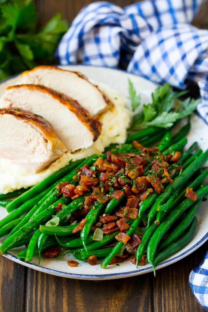 Green Beans with Bacon Recipe | Bacon Green Beans #bacon #greenbeans #sidedish #thanksgiving #veggies #dinner #ezlod Green beans with bacon served alongside turkey and mashed potatoes.