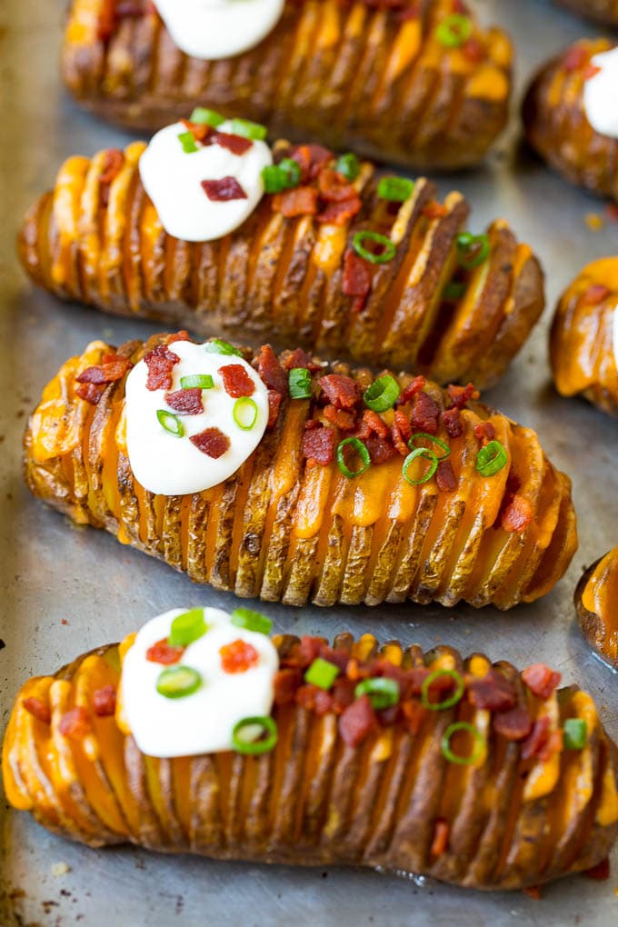 Hasselback Potatoes Recipe #potatoes #bacon #sidedish #cheese #dinner #ezlod Hasselback potatoes filled with melted cheese, then topped with bacon, sour cream and green onions.