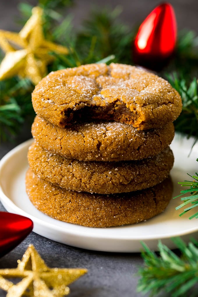 Molasses Cookies Recipe | Spice Cookies #cookies #baking #christmas #dessert #ezlod A stack of molasses cookies with a bite taken out of one.