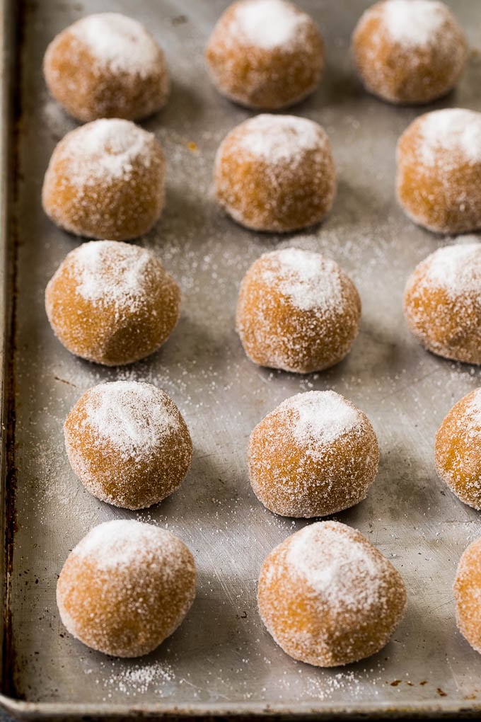 Molasses Cookies Recipe | Spice Cookies #cookies #baking #christmas #dessert #ezlod Balls of cookie dough rolled in sugar on a sheet pan.