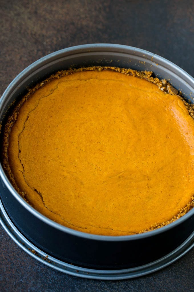 Pumpkin Pie Cheesecake Recipe | Pumpkin Cheesecake #cake #cheesecake #pumpkin #fall #thanksgiving #dessert #ezlod A baked pumpkin cheesecake in a pan.