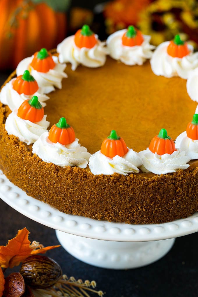 Pumpkin Pie Cheesecake Recipe | Pumpkin Cheesecake #cake #cheesecake #pumpkin #fall #thanksgiving #dessert #ezlod Pumpkin pie cheesecake topped with whipped cream and candy pumpkins.