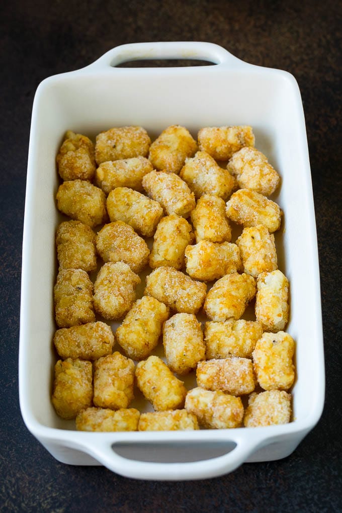 Sausage Egg Casserole Recipe | Egg Casserole #eggs #sausage #potato #cheese #casserole #breakfast #brunch #ezlod Potato tots in a casserole dish.