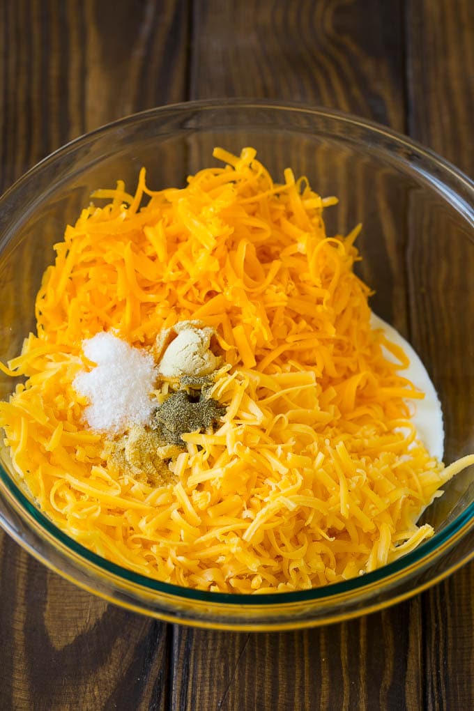 Southern Mac and Cheese | Baked Macaroni and Cheese #pasta #macandcheese #dinner #comfortfood #cheese #ezlod A bowl of milk, cream, two types of shredded cheese and seasonings.