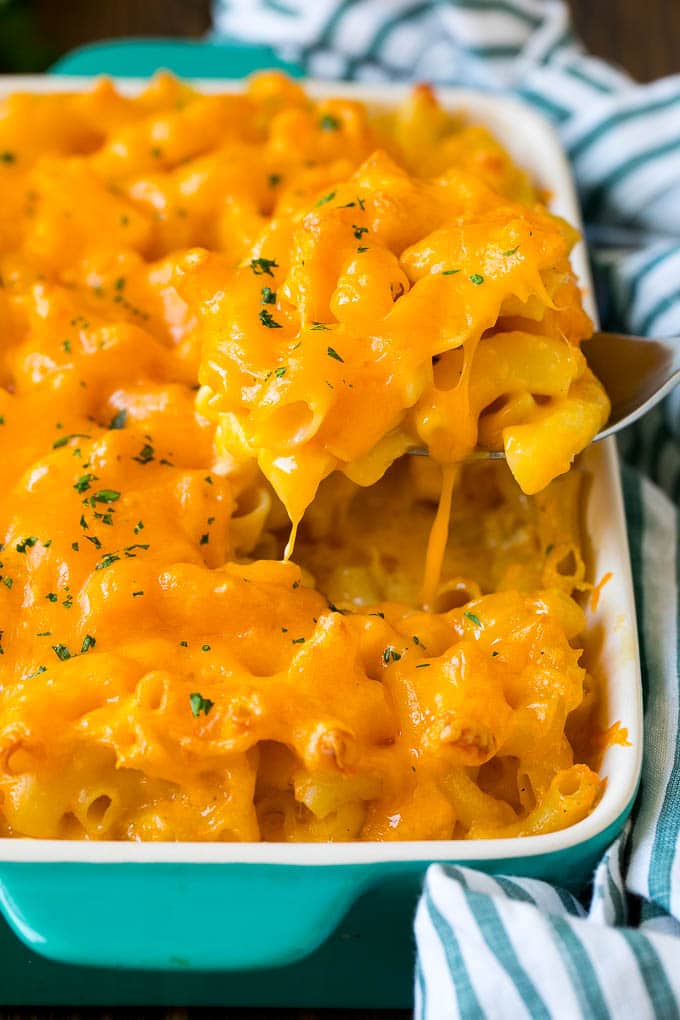 Southern Mac and Cheese | Baked Macaroni and Cheese #pasta #macandcheese #dinner #comfortfood #cheese #ezlod A spoon serving up a portion of Southern mac and cheese.